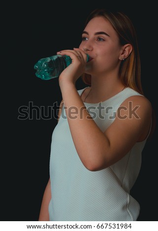 Young pretty girl drinks fresh water