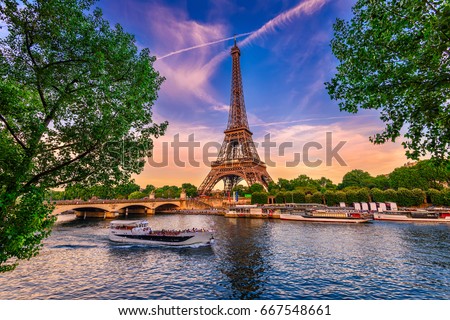 Paris Eiffel Tower and river Seine at sunset in Paris, France. Eiffel Tower is one of the most iconic landmarks of Paris. Royalty-Free Stock Photo #667548661