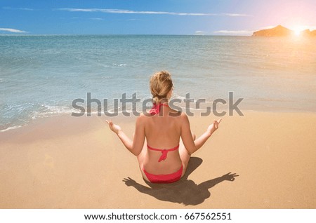 Woman on beach meditating