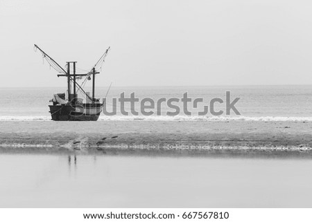Fishing Boat landing on beach with black and white . Thailand tourist attraction.