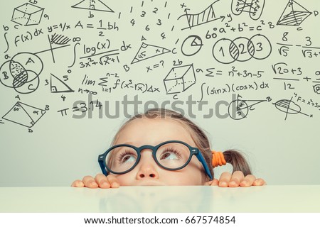 beautiful cute little girl with math formulas and problems Royalty-Free Stock Photo #667574854