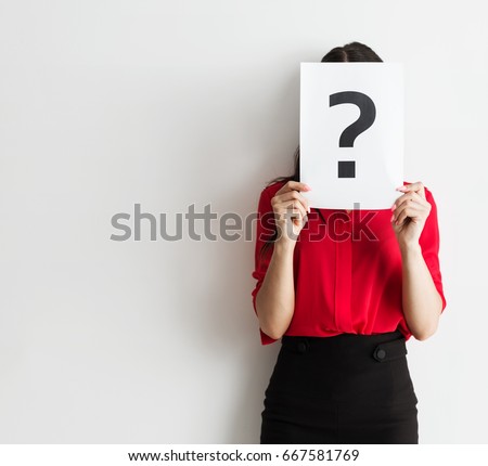 Anonymous business woman holding a question mark Royalty-Free Stock Photo #667581769