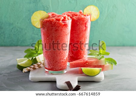 Watermelon slushie with lime, summer refreshing drink in tall glasses Royalty-Free Stock Photo #667614859