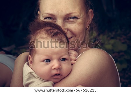 Mother sincerely hugging her child. Conceptual picture symbolizing baby care and love. 