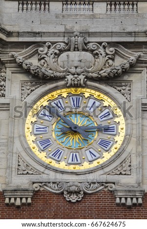 The beautiful clock on the belfry of the Chamber of Commerce and Industry in the historic city of Lille, France. 