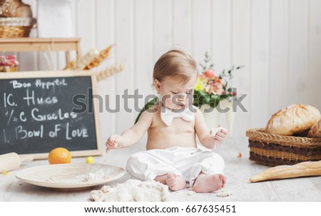 the little girl plays with the test in a bakery
