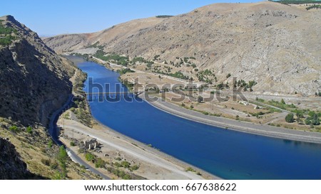 View on the Euphrates River in Turkey near the Ataturk Dam. Together with the Tigris, the Euphrates is one of the two defining rivers of Mesopotamia. Royalty-Free Stock Photo #667638622