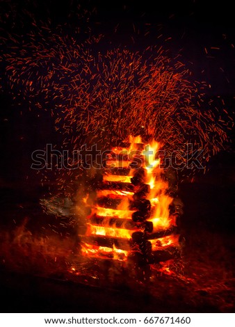 The burning of bonfire in the night on a black background.