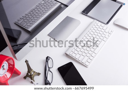 Office Computer on white wooden table and mobile phone