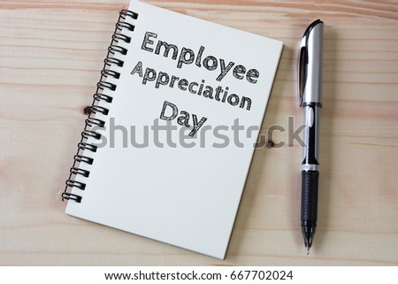 Text Employee appreciation day on white paper book and office supplies on wood desk / business concept Royalty-Free Stock Photo #667702024