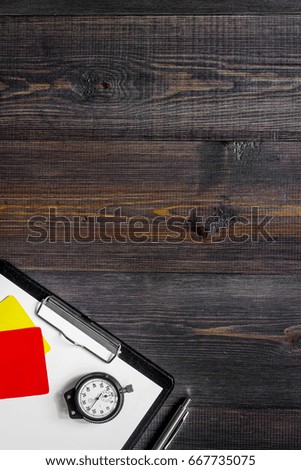 Yellow and red referee cards and stopwatch on wooden background top view copyspace