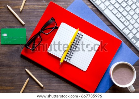 Scholarship or grant for education concept. Dollar sign, notebook and keyboard on wooden table top view