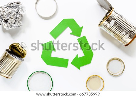 Paper recycle sign with steel garbage on white background top view