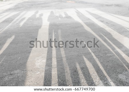 shadow of many people on street background