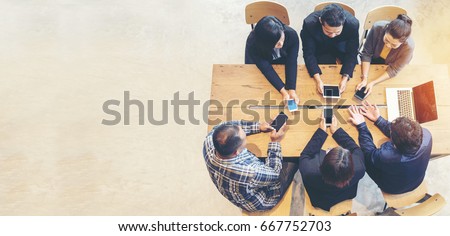 Unified Collaboration Marketing Team Collaborate in office meeting. Group of people using smartphone working Sales Team. Marketing communications strategy in business office. Banner with copy space.