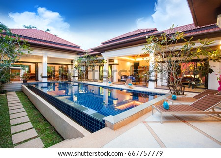 real luxury exterior design pool villa with interior design living room  home, house ,building Royalty-Free Stock Photo #667757779