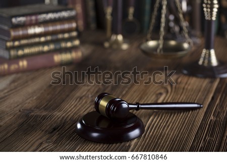 Gavel on a wooden table. Place for typography. Law symbols. Lawyer theme.