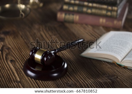 Gavel on a wooden table. Place for typography. Law symbols. Lawyer theme.