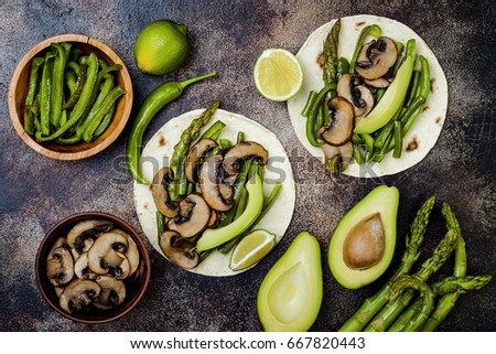 Grilled portobello, asparagus, bell peppers, green beans fajitas. Poblano mushroom tacos with jalapeno, cilantro, avocado crema. Vegan tacos with green summer vegetables.