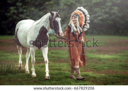 Beauty young asian girl with make up like native american woman and walking with american paint horse in Thailand.