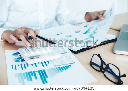 Finances Saving Economy concept. Female accountant or banker use calculator.
 Royalty-Free Stock Photo #667834183