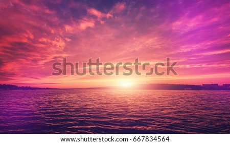 fantastic colorful landscape.  overcast clouds glowing in sunlight at sunset over the lake. picturesque view. color in nature. natural creative picture. instagram toning