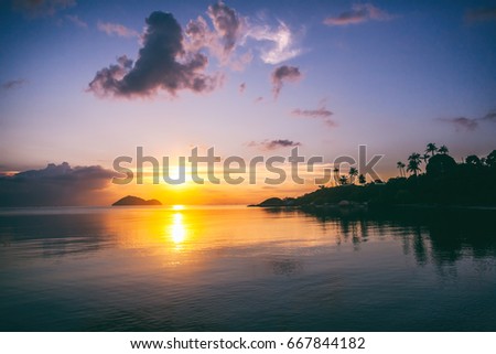 Magnificent beautiful bright tropical sunset, sun, palms, sandy beach