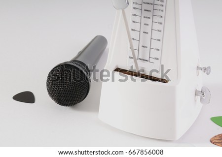 Metronome and microphone on a white background
