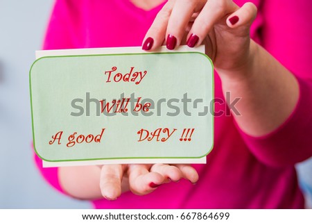 Female hand is holding a poster with text - today will be a good day. This Will Be a Great Day Today, Calendar Date, Good Positive Attitude. my day - today. board with the motivating positive message