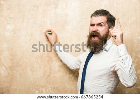 marketing planning of bearded man with long beard and hair on shouting face in tie and white shirt write on beige wall background with chalk and raised finger,  business and marketing, education