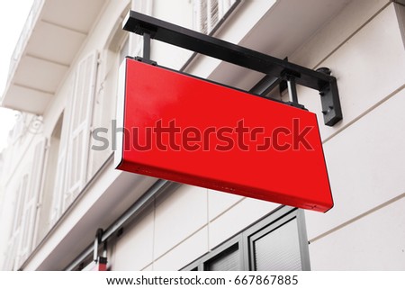 Red logo sign on the wall