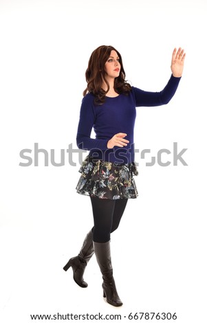 full length portrait of a girl wearing casual clothes, standing pose against a white studio background.