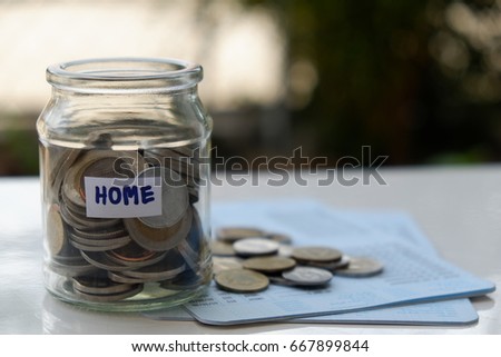 Coin in glass jar on bankbook