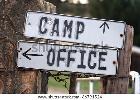 Camp and office signs on gate