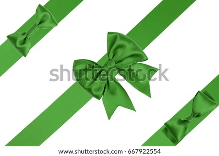 Gift green satin bow with three ribbons on white background