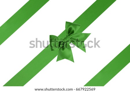 Single green bow with three satin ribbons on white background