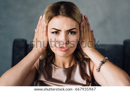 Happy woman covering her ears with hands