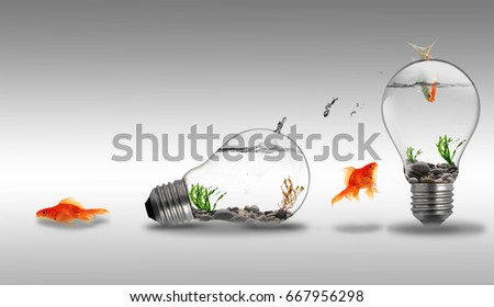 Gold fish jumping to other water inside an electric light bulb, concept of freedom,change, challenge or barrier