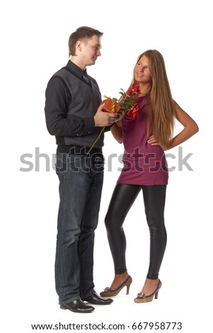 The young enamoured man gives a gift to the girlfriend on a white background.