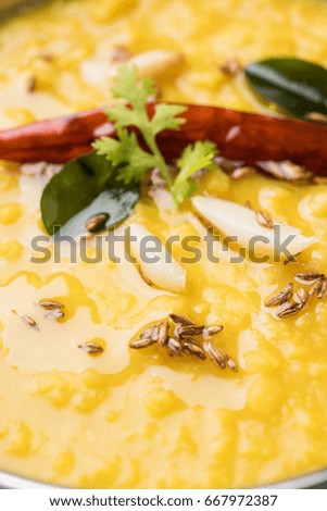 closeup picture of Indian popular food Dal fry or traditional Dal Tadka Curry served in a bowl, isolated over white background, selective focus showing details