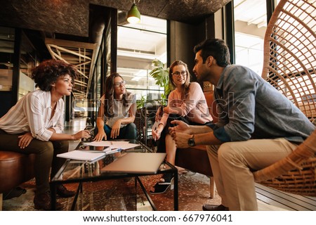Group of creative people having a meeting in a modern office. Business people having conversation over new project. Royalty-Free Stock Photo #667976041