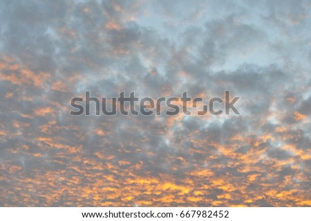 Background of blue sky with clouds sun set in orange colour.  