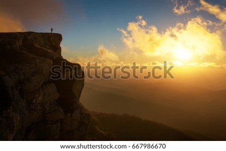 Beautiful mountain landscape with sunset sky in autumn time. Photographer takes pictures on top of the mountain 

