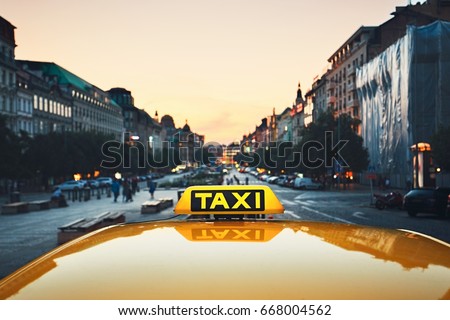 Taxi car on the city street at dusk.  Wenceslas Square, Prague, Czech Republic Royalty-Free Stock Photo #668004562