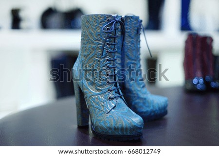 Spring, autumn season women's boots on blurry shop stage background