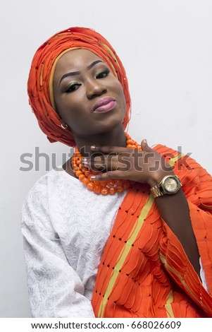 An African lady dressing in native attire with beautiful facial makeup