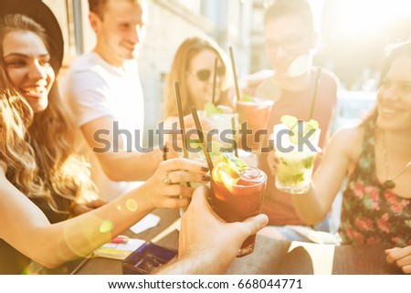 Summer party. Friends at cafe drinking and having fun Royalty-Free Stock Photo #668044771