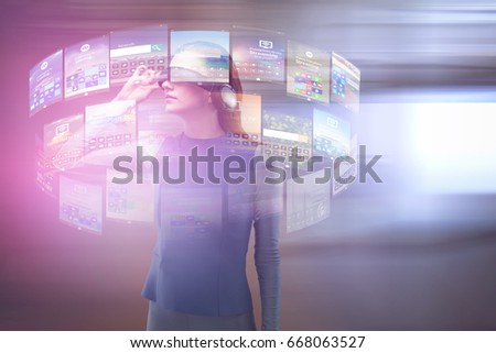 Woman experiencing virtual reality headset against view of office corridor and workspace