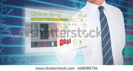 Businessman pointing with his finger against stocks and shares