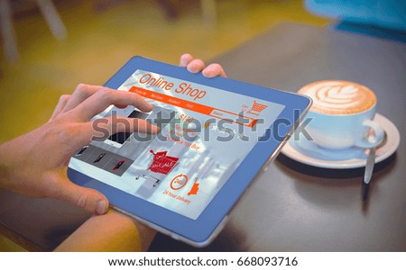 Phoneses for sale displayed on web page against  close-up of digital tablet and coffee on table Close-up of digital tablet and coffee on table in the coffee shop